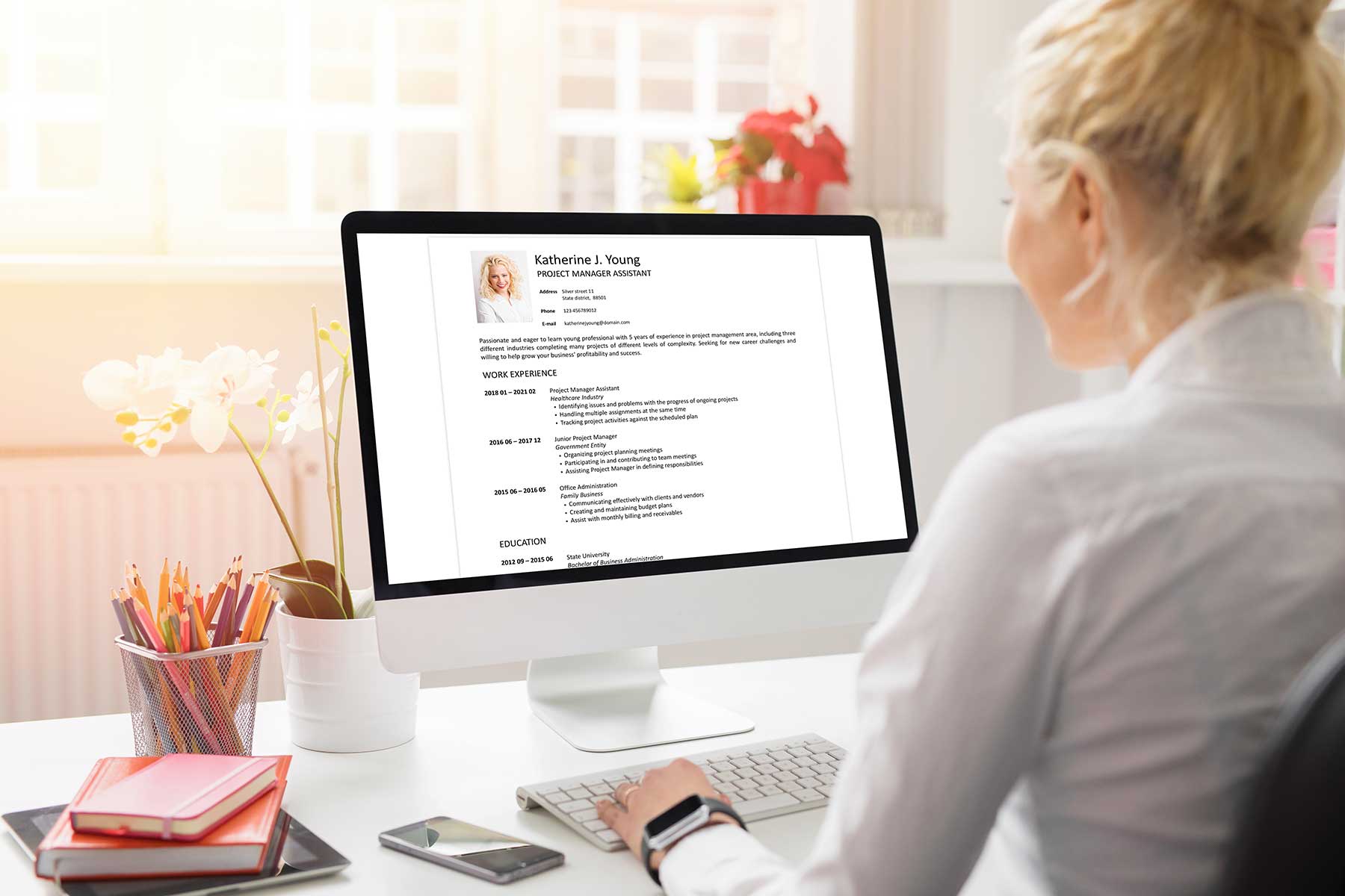 Professional resume writer reviewing a client's resume on desktop computer Professional resume writer reviewing a client's resume on desktop computer