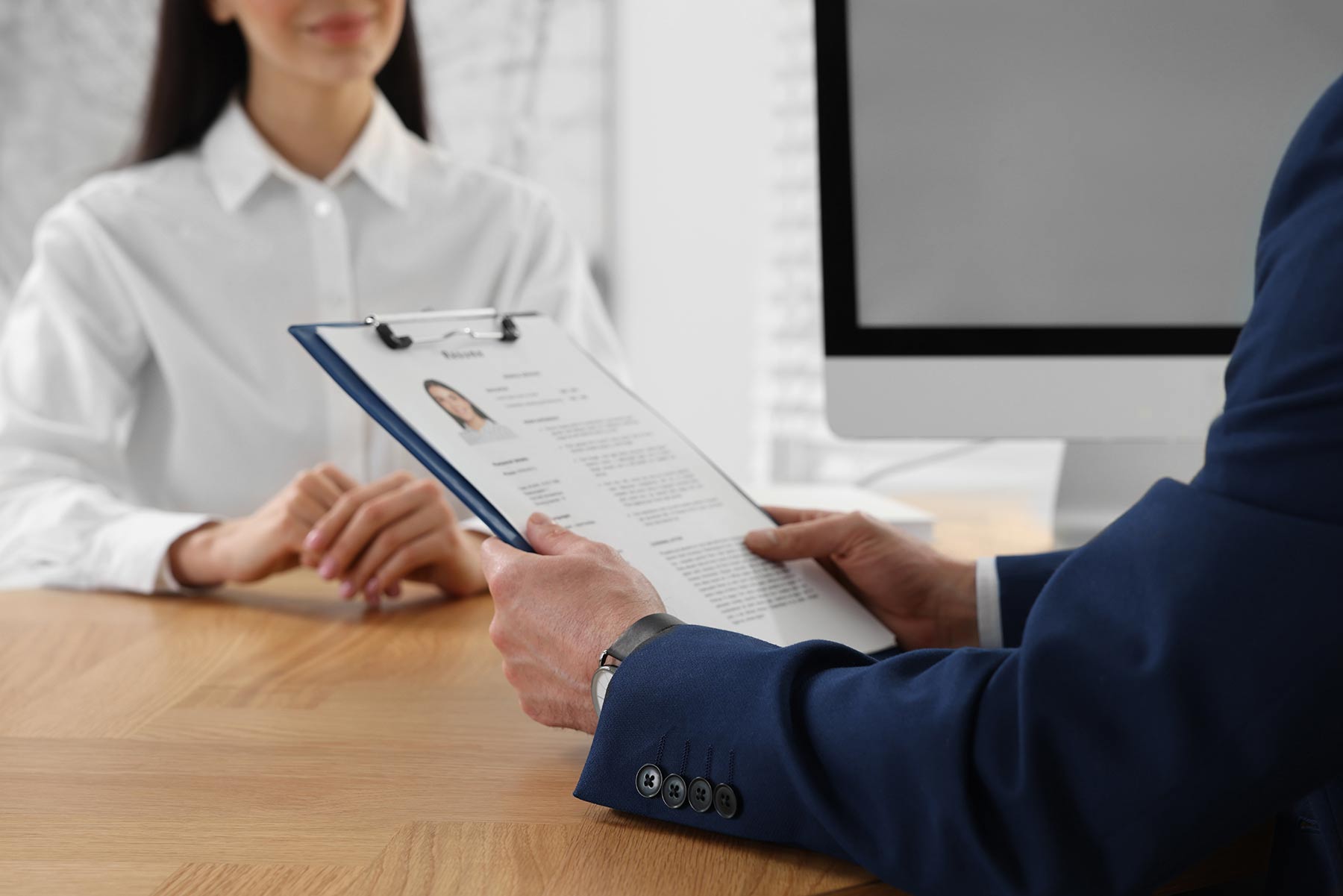 A recruiter reviewing a candidate’s resume during an interview
